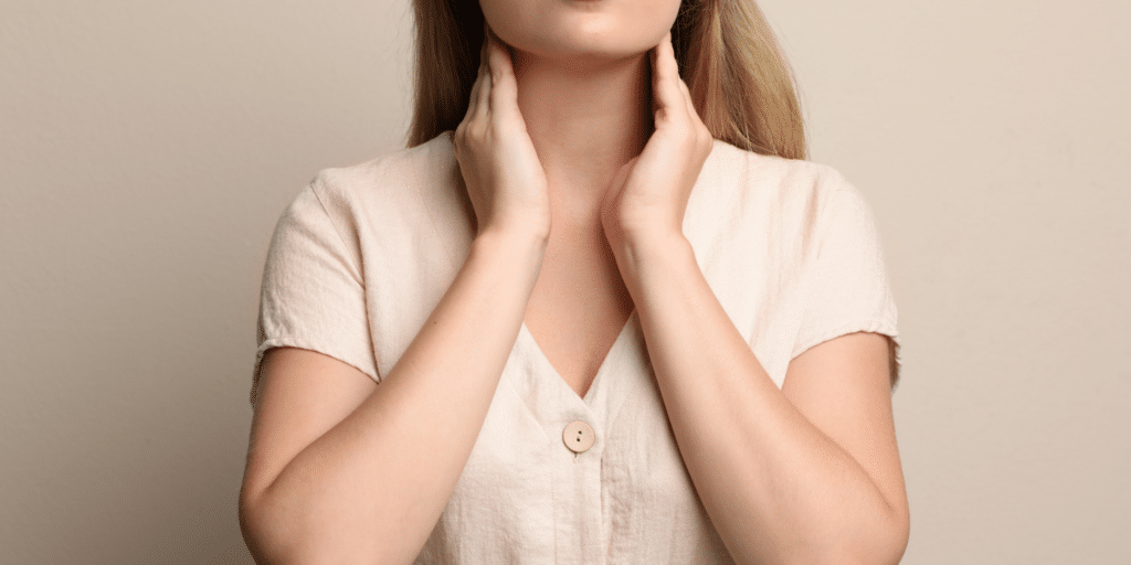 Women holding her thyroid